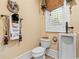 Bathroom with a urinal, toilet, window and cowboy themed decor at 878 Middle Fork Trl, Suwanee, GA 30024