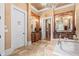 Luxurious bathroom with granite counters and mirrors at 878 Middle Fork Trl, Suwanee, GA 30024