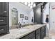 Bathroom featuring granite countertop and black cabinets at 878 Middle Fork Trl, Suwanee, GA 30024