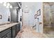 Lavish bathroom featuring double sinks and a tiled shower at 878 Middle Fork Trl, Suwanee, GA 30024