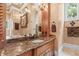 Primary bathroom with granite counters, double sinks, chandelier and walk-in shower at 878 Middle Fork Trl, Suwanee, GA 30024