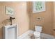 Well-lit bathroom with a toilet and standing urinal at 878 Middle Fork Trl, Suwanee, GA 30024