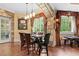 Elegant dining area featuring stone archways, wood floors, and natural light at 878 Middle Fork Trl, Suwanee, GA 30024