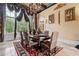 Formal dining room with a large window, chandelier, and elegant decor at 878 Middle Fork Trl, Suwanee, GA 30024