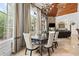 Dining area with a vaulted ceiling, large windows, and access to the living room at 878 Middle Fork Trl, Suwanee, GA 30024