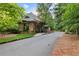 Stone guard house at gated entrance to the property with a paved road leading in at 878 Middle Fork Trl, Suwanee, GA 30024