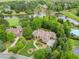 Stunning exterior of a luxury home with lush landscaping and a circular driveway at 878 Middle Fork Trl, Suwanee, GA 30024