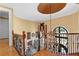 The grand staircase in the foyer features custom ironwork and hardwood floors at 878 Middle Fork Trl, Suwanee, GA 30024