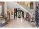 Elegant foyer with marble floors, a grand staircase, and ornate details at 878 Middle Fork Trl, Suwanee, GA 30024