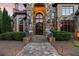 Detailed stone entryway with a walkway leading to the front door at 878 Middle Fork Trl, Suwanee, GA 30024
