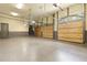 Spacious garage with multiple overhead doors, epoxy flooring, and neutral walls at 878 Middle Fork Trl, Suwanee, GA 30024