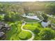 Beautiful aerial view of the golf course with winding paths, water features, and mature trees at 878 Middle Fork Trl, Suwanee, GA 30024