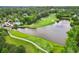 Picturesque aerial view of the golf course with a lake, bridge, and lush greenery at 878 Middle Fork Trl, Suwanee, GA 30024