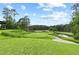 Expansive view of the green and a pond on this beautiful golf course at 878 Middle Fork Trl, Suwanee, GA 30024
