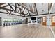 Spacious gym area with rows of bikes, large mirrors, wood floors and beamed ceilings at 878 Middle Fork Trl, Suwanee, GA 30024