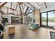 Well-equipped gym with modern exercise equipment, stone accents, exposed beams, and abundant natural light at 878 Middle Fork Trl, Suwanee, GA 30024