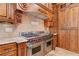 Professional-grade range in gourmet kitchen with custom cabinets and granite counters, perfect for culinary enthusiasts at 878 Middle Fork Trl, Suwanee, GA 30024