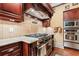 Gourmet kitchen featuring granite counters and stainless steel appliances at 878 Middle Fork Trl, Suwanee, GA 30024