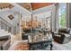 Bright, open living room with soaring ceilings, ornate staircase, and seamless flow into the kitchen and dining areas at 878 Middle Fork Trl, Suwanee, GA 30024