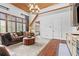 Open living room features hardwood floors, comfortable sofa, and a window with great light at 878 Middle Fork Trl, Suwanee, GA 30024