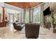 Spacious living room with stone fireplace, wood ceiling, and lots of natural light at 878 Middle Fork Trl, Suwanee, GA 30024