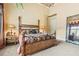 Spacious main bedroom features a tall ceiling, chandelier, bedside tables, and ample natural light at 878 Middle Fork Trl, Suwanee, GA 30024