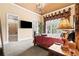 Elegant main bedroom boasts a decorative window treatment, chandelier, and ensuite bathroom at 878 Middle Fork Trl, Suwanee, GA 30024