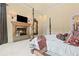 Main bedroom with fireplace and luxury four-poster bed at 878 Middle Fork Trl, Suwanee, GA 30024