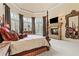 A luxurious main bedroom with a fireplace, sitting area and stylish decor at 878 Middle Fork Trl, Suwanee, GA 30024