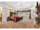 Spacious carpeted main bedroom featuring a tray ceiling, many windows with custom valences, and a decorative fireplace at 878 Middle Fork Trl, Suwanee, GA 30024