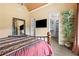 Large main bedroom features a high ceiling, large mirror, ensuite, and adjacent walk-in closet at 878 Middle Fork Trl, Suwanee, GA 30024