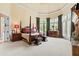 Spacious bedroom with large windows, luxury four-poster bed and elegant fireplace at 878 Middle Fork Trl, Suwanee, GA 30024