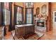 Executive office with fireplace, chandelier, and built-in storage at 878 Middle Fork Trl, Suwanee, GA 30024