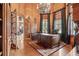 Ornate executive office featuring custom wood paneling and a grand chandelier at 878 Middle Fork Trl, Suwanee, GA 30024