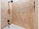 Close-up of the tiled shower with a shower head and tub, showcasing quality craftsmanship at 878 Middle Fork Trl, Suwanee, GA 30024