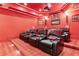 Luxurious home theater boasts tiered seating with plush leather recliners and a high-quality projection system at 878 Middle Fork Trl, Suwanee, GA 30024