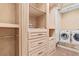 Walk-in Closet with built in cabinets and a washer and dryer at 878 Middle Fork Trl, Suwanee, GA 30024