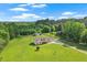Aerial view of a beautiful home surrounded by lush green trees, and open yard at 24 Fossetts Nw Cv, Cartersville, GA 30121