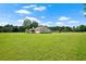 Expansive green lawn surrounding a ranch home with a screened-in porch, perfect for outdoor enjoyment at 24 Fossetts Nw Cv, Cartersville, GA 30121
