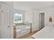 Bright bathroom features a large tub, stone tile detail and hardwood floors at 24 Fossetts Nw Cv, Cartersville, GA 30121