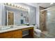 Bathroom with a granite-look countertop, soft gray paint, walk-in shower, and an attractive decor at 24 Fossetts Nw Cv, Cartersville, GA 30121