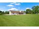 Sprawling green lawn surrounds this ranch home with a screened in porch and a large propane tank in the yard at 24 Fossetts Nw Cv, Cartersville, GA 30121