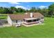 Ranch style home featuring a screened in porch and a large green lawn with mature trees in the background at 24 Fossetts Nw Cv, Cartersville, GA 30121