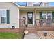 Inviting front porch with decorative plants and seating area, enhancing the home's curb appeal at 24 Fossetts Nw Cv, Cartersville, GA 30121