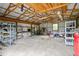 Large, unfinished garage space with exposed rafters and shelving, ideal for storage or workshop at 24 Fossetts Nw Cv, Cartersville, GA 30121
