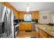 Open kitchen with a large stainless steel refrigerator and granite counters, ready for cooking and entertaining at 24 Fossetts Nw Cv, Cartersville, GA 30121