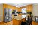 Well-lit kitchen featuring stainless steel appliances and a center island with barstool seating at 24 Fossetts Nw Cv, Cartersville, GA 30121