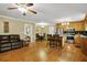 Expansive hardwood floors connect the stainless kitchen, seating area, and dining space at 24 Fossetts Nw Cv, Cartersville, GA 30121