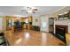 Open concept living room with stainless steel kitchen, fireplace, and hardwood floors at 24 Fossetts Nw Cv, Cartersville, GA 30121