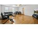 Large, open living room with hardwood floors and a comfortable sofa, providing ample space for relaxation and entertainment at 24 Fossetts Nw Cv, Cartersville, GA 30121